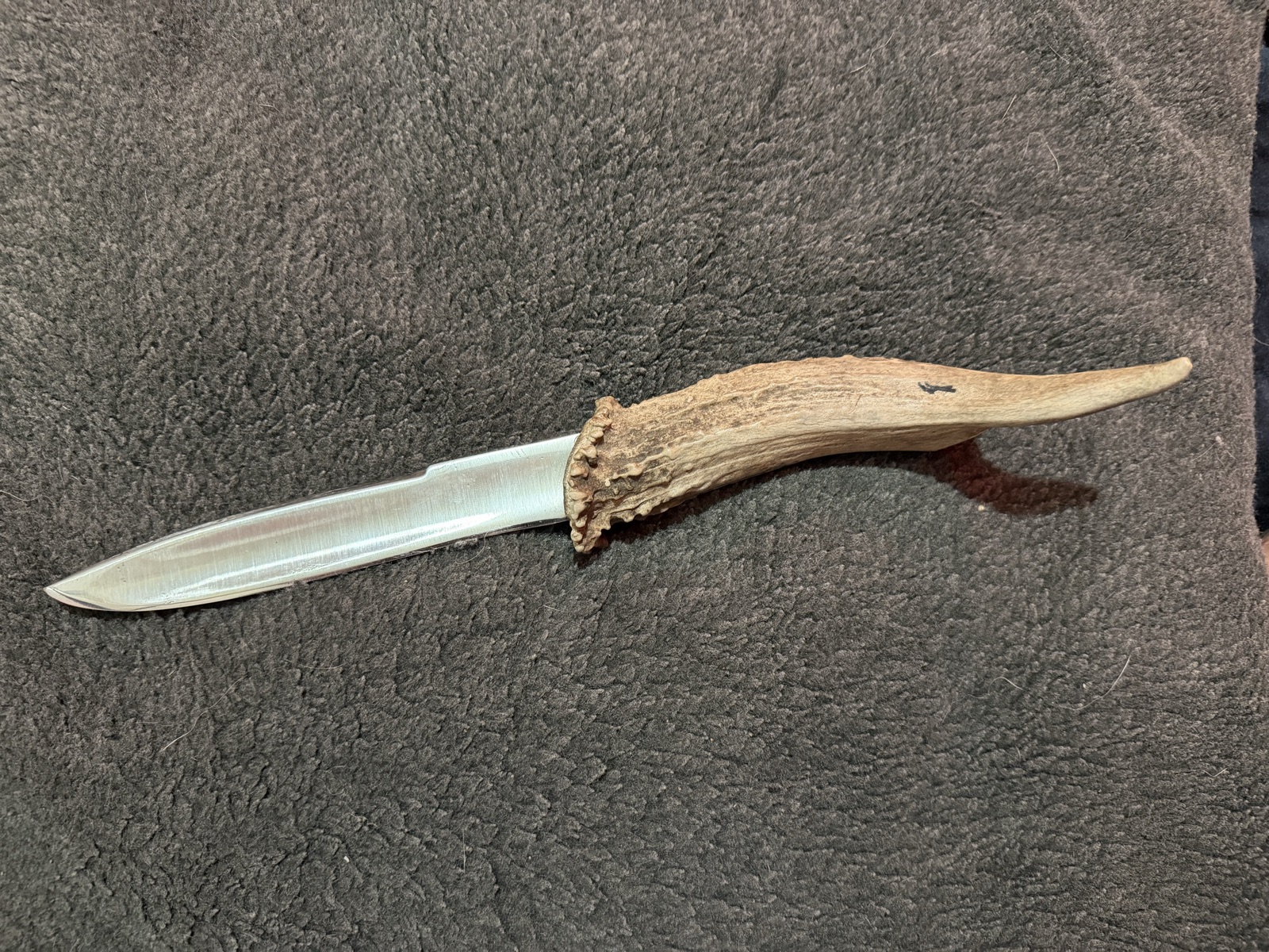 Long handmade knife fitted with a natural antler handle