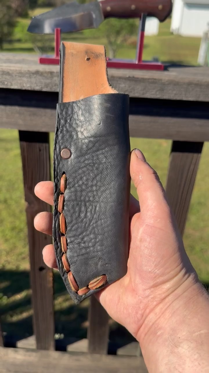 Black hand-stitched leather knife sheath with tan lacing