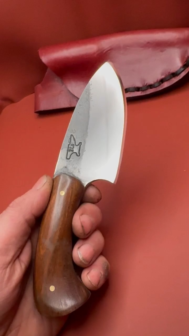Compact polished Tulos hunting knife with a curved wood handle and maker mark