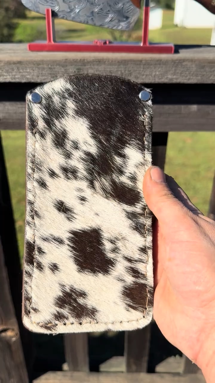 Hand-stitched black and white cowhide knife sheath