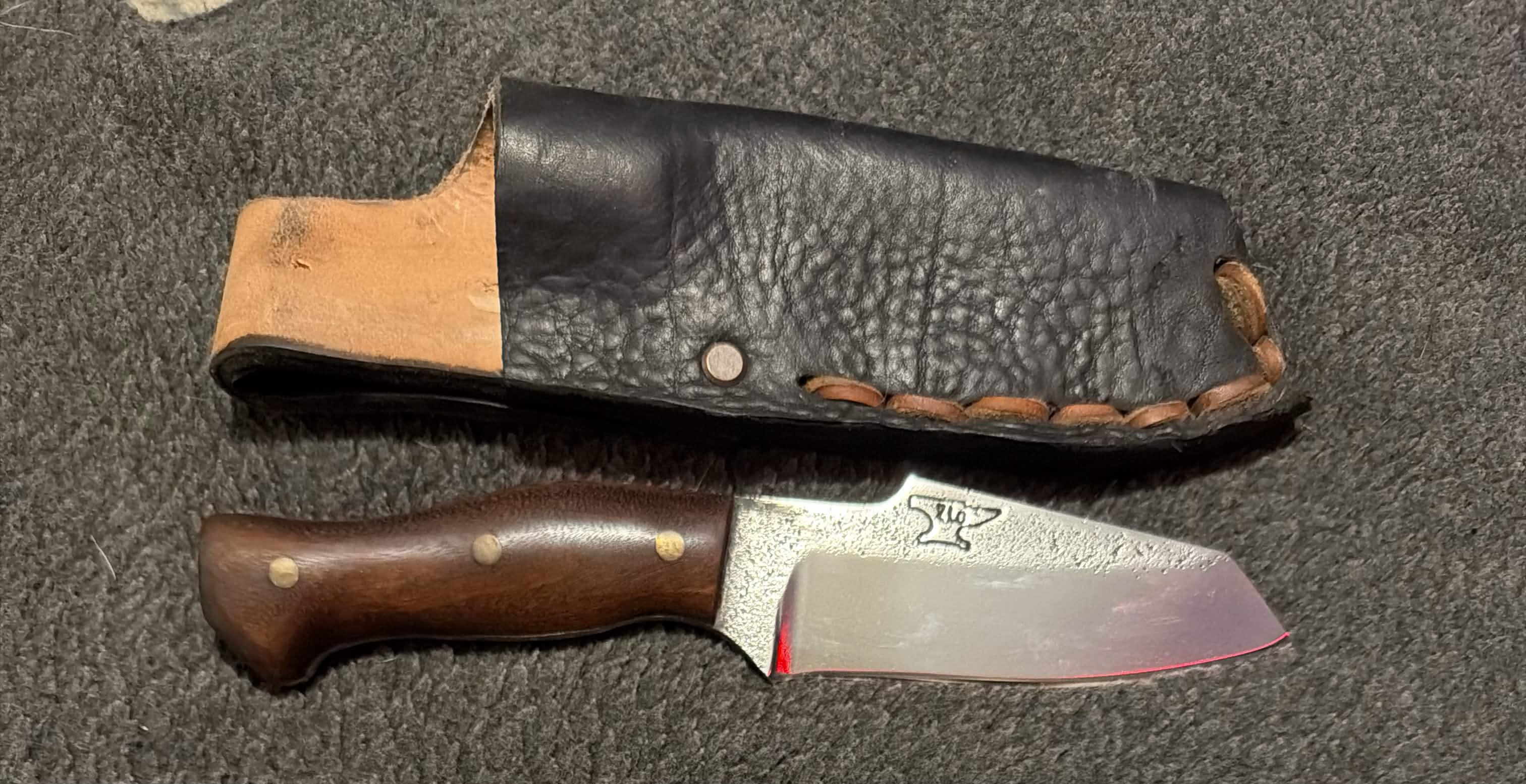 Compact handmade Tulos field knife with a wood handle and black leather sheath
